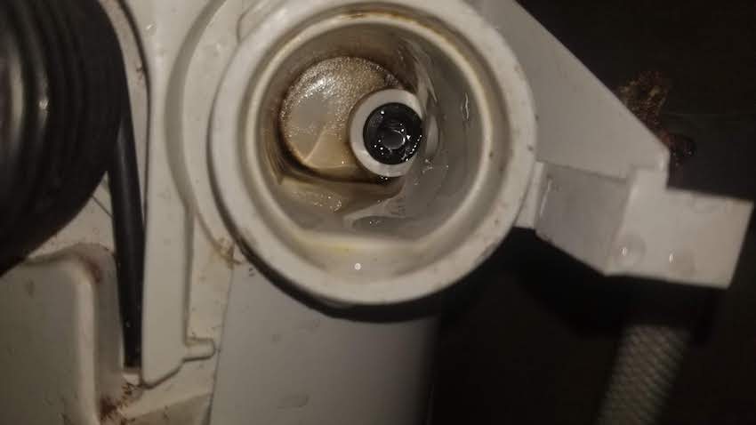 Image of worn RV toilet inlet valve. Rubber seal wears easily.
